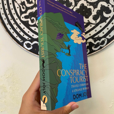 Sách - The Conspiracy Tourist: Travels Through a Strange World by Dom Joly | Travel Nonfiction